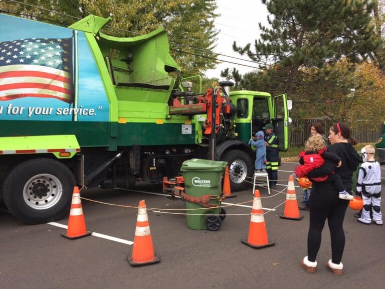 Children And Their Family Checking Out Walters Waste Truck