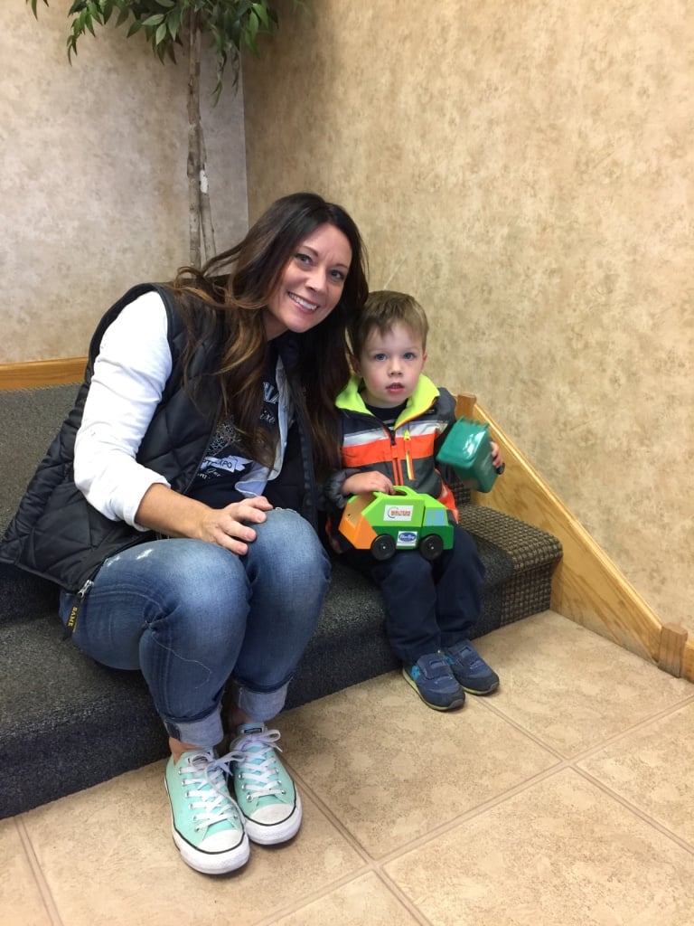 Parent Smiling With Their Young Kid In Lobby